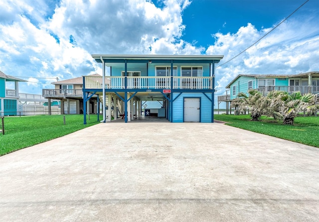 1331 County Road 230, Sargent, TX 77414 - coastal home with a carport, covered porch, driveway, and a front lawn