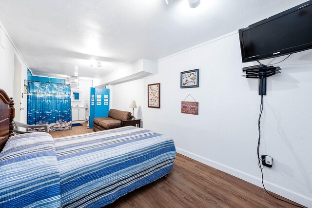 1331 County Road 230, Sargent, TX 77414 - bedroom with baseboards and wood finished floors