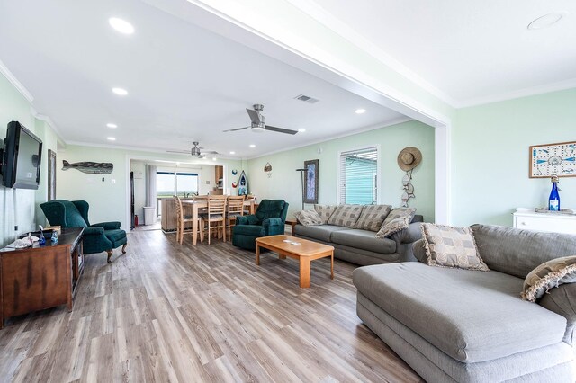 1331 County Road 230, Sargent, TX 77414 - living room featuring ornamental molding, healthy amount of natural light, light wood-style flooring, a ceiling fan, and recessed lighting