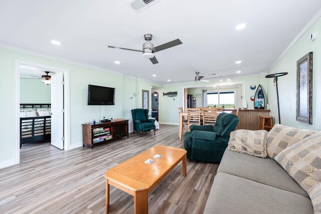 1331 County Road 230, Sargent, TX 77414 - living room with a ceiling fan, ornamental molding, light wood-type flooring, baseboards, and recessed lighting