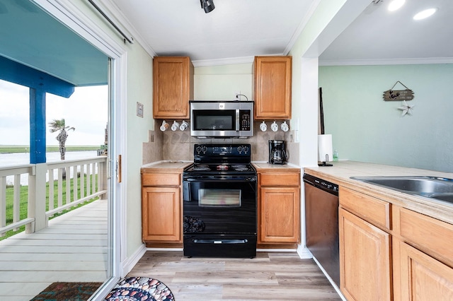1331 County Road 230, Sargent, TX 77414 - kitchen with appliances with stainless steel finishes, plenty of natural light, backsplash, light countertops, and crown molding