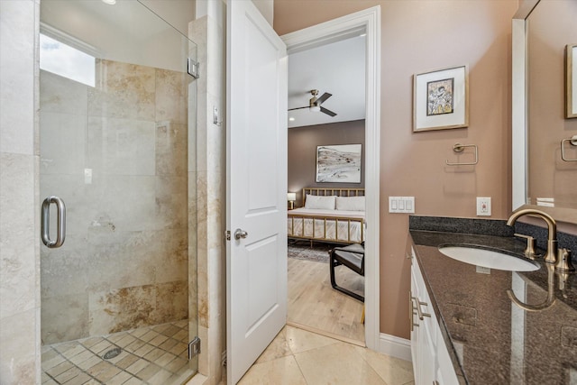 1250 Sampson St, Houston, TX 77003 - bathroom with connected bathroom, vanity, a stall shower, a ceiling fan, and tile patterned floors