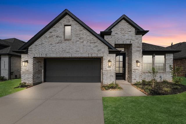 21318 Oakley Claremont Ct, Magnolia, TX 77355 - french country style house with driveway, a front lawn, brick siding, and an attached garage
