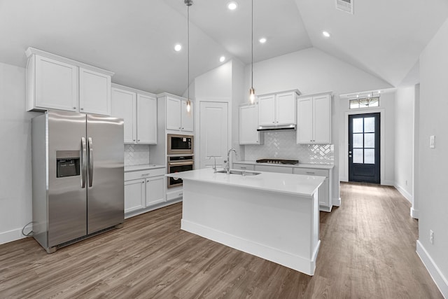 21318 Oakley Claremont Ct, Magnolia, TX 77355 - kitchen with stainless steel appliances, a sink, white cabinets, light countertops, and backsplash