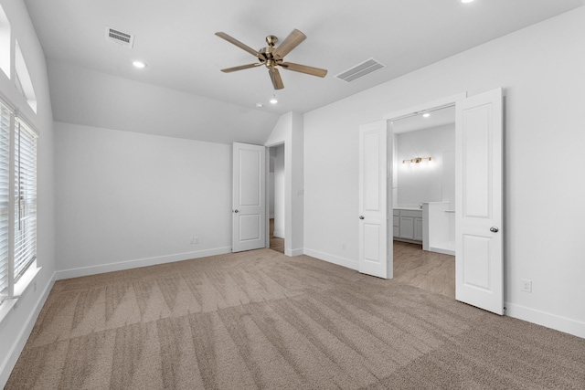 21318 Oakley Claremont Ct, Magnolia, TX 77355 - unfurnished bedroom with light carpet, recessed lighting, baseboards, connected bathroom, and vaulted ceiling