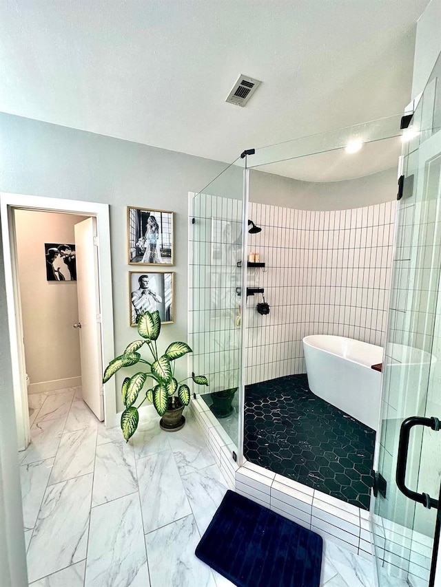 5018 Darling St, Houston, TX 77007 - full bathroom featuring marble look tiles, a shower stall, a freestanding bath, toilet, and baseboards