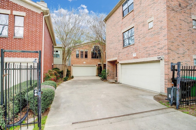 5018 Darling St, Houston, TX 77007 - view of side of property featuring an attached garage, concrete driveway, and brick siding