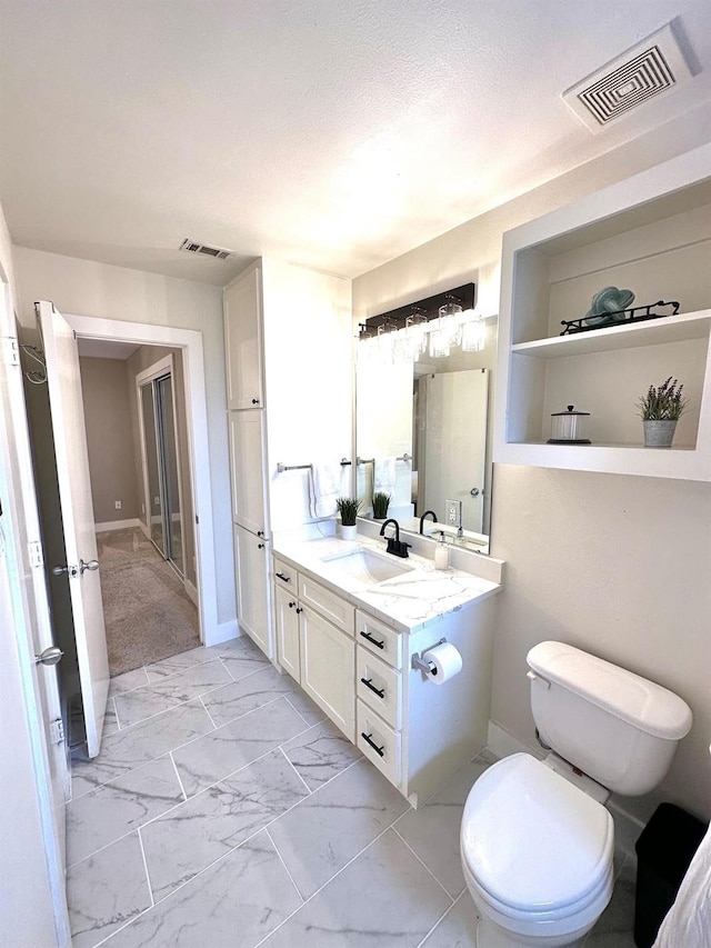 5018 Darling St, Houston, TX 77007 - bathroom featuring vanity, marble look tile flooring, toilet, and baseboards