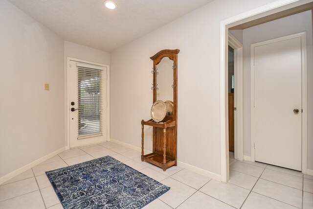 8028 Oakwood Forest Dr, Houston, TX 77040 - foyer with light tile patterned floors, baseboards, and recessed lighting