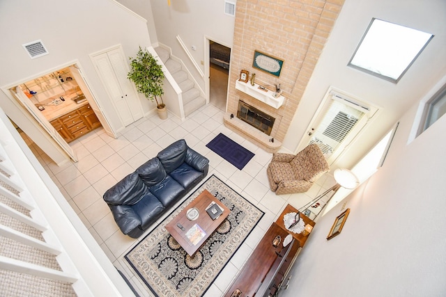 8028 Oakwood Forest Dr, Houston, TX 77040 - tiled living room featuring a high ceiling, baseboards, and stairway