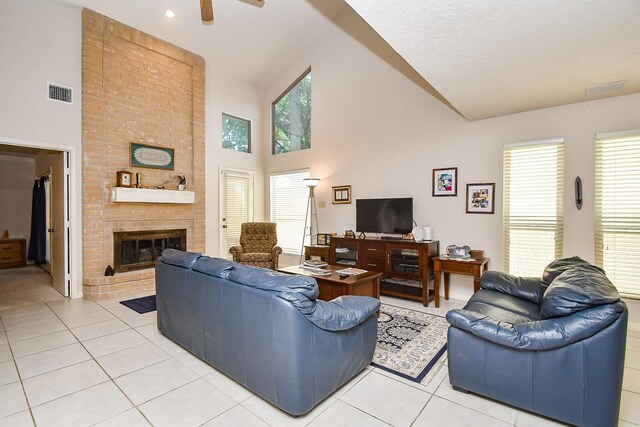 8028 Oakwood Forest Dr, Houston, TX 77040 - living area with high vaulted ceiling, light tile patterned floors, healthy amount of natural light, a fireplace, and ceiling fan