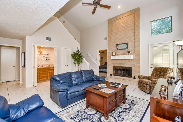 8028 Oakwood Forest Dr, Houston, TX 77040 - living room with high vaulted ceiling, light tile patterned flooring, a ceiling fan, a fireplace, and baseboards