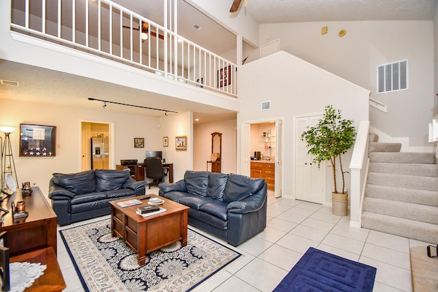 8028 Oakwood Forest Dr, Houston, TX 77040 - living room with high vaulted ceiling, a desk, stairs, light tile patterned floors, and a ceiling fan