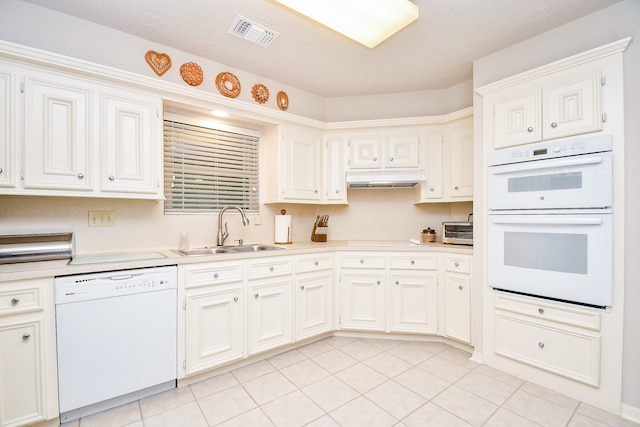 8028 Oakwood Forest Dr, Houston, TX 77040 - kitchen featuring white appliances, a sink, light countertops, light tile patterned floors, and under cabinet range hood