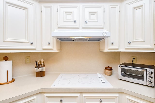 8028 Oakwood Forest Dr, Houston, TX 77040 - kitchen featuring white electric stovetop, range hood, light countertops, and white cabinets