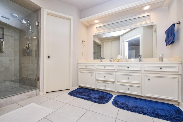 8028 Oakwood Forest Dr, Houston, TX 77040 - bathroom with double vanity, tile patterned floors, a stall shower, and baseboards