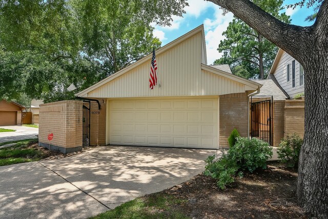 8028 Oakwood Forest Dr, Houston, TX 77040 - mid-century inspired home with brick siding, driveway, and a garage