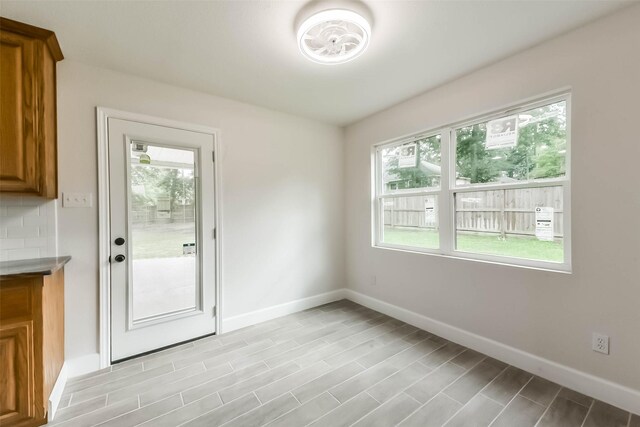 9096 N Comanche Cir, Willis, TX 77378 - doorway to outside featuring baseboards and light wood-style flooring