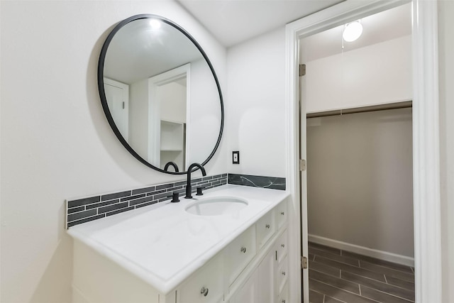 9096 N Comanche Cir, Willis, TX 77378 - bathroom featuring vanity, wood finished floors, and baseboards