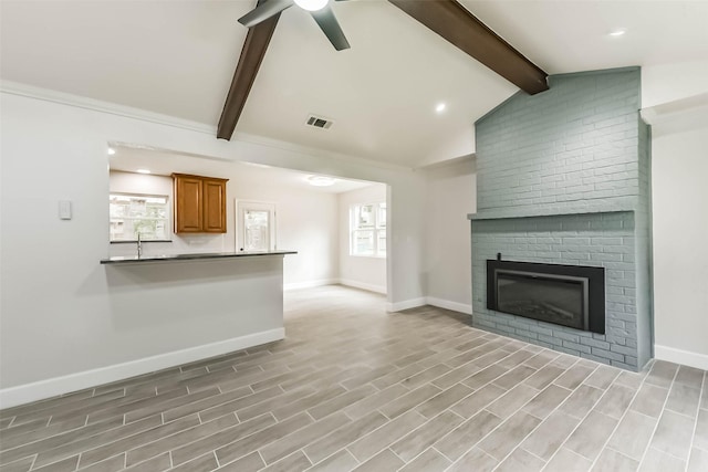 9096 N Comanche Cir, Willis, TX 77378 - unfurnished living room with ceiling fan, a brick fireplace, baseboards, light wood-type flooring, and recessed lighting