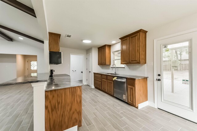9096 N Comanche Cir, Willis, TX 77378 - kitchen with dishwasher, a sink, a peninsula, baseboards, and brown cabinets