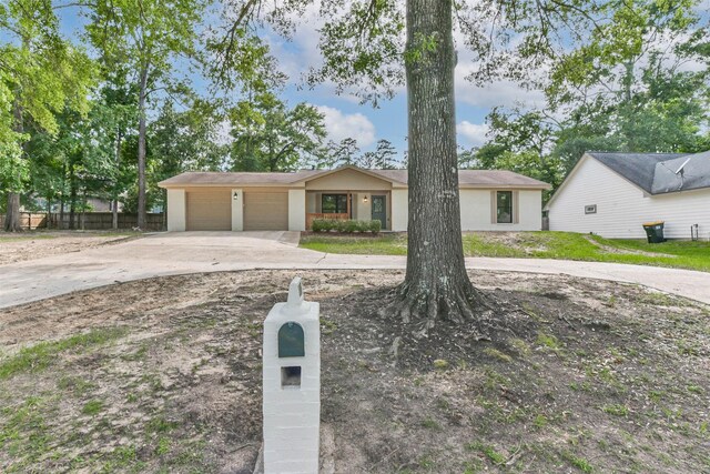 9096 N Comanche Cir, Willis, TX 77378 - view of front of house featuring concrete driveway and an attached garage