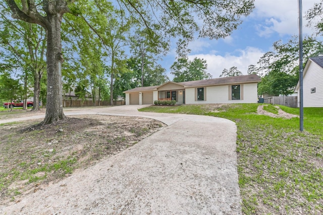 9096 N Comanche Cir, Willis, TX 77378 - ranch-style house with a garage, driveway, and stucco siding