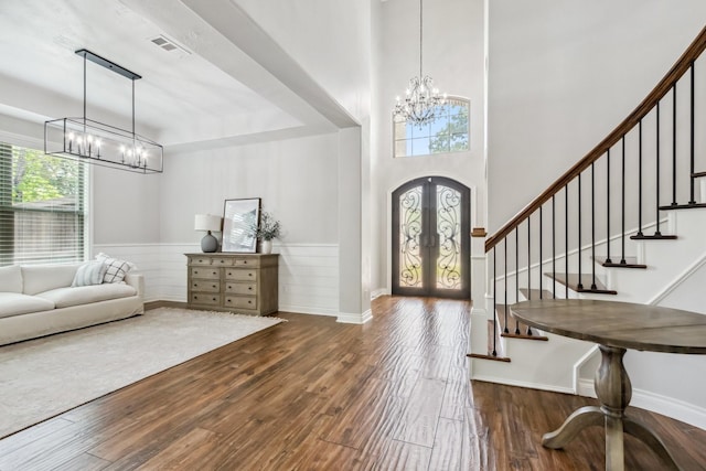 1935 Invermere Dr, Spring, TX 77386 - foyer with a chandelier, stairway, wood finished floors, french doors, and wainscoting