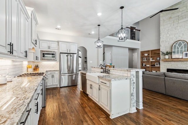 1935 Invermere Dr, Spring, TX 77386 - kitchen with appliances with stainless steel finishes, open floor plan, dark wood-style flooring, backsplash, and recessed lighting