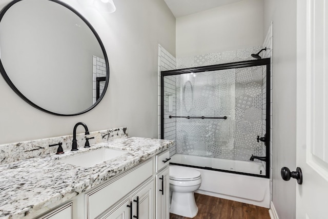 1935 Invermere Dr, Spring, TX 77386 - bathroom featuring wood finished floors, vanity, and bath / shower combo with glass door