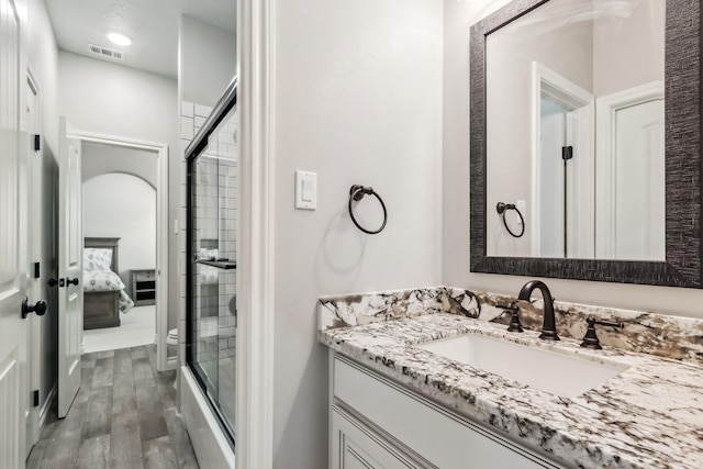1935 Invermere Dr, Spring, TX 77386 - ensuite bathroom with vanity, an enclosed shower, and wood finished floors