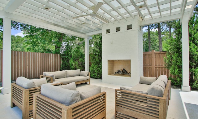 1935 Invermere Dr, Spring, TX 77386 - view of patio with an outdoor living space with a fireplace, a ceiling fan, and view of scattered trees