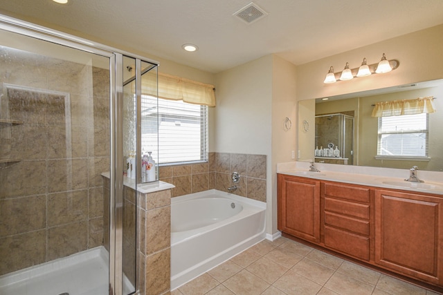 13018 Foxwood Creek Ln, Houston, TX 77044 - full bathroom featuring tile patterned flooring, a garden tub, a shower stall, double vanity, and recessed lighting