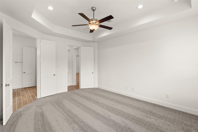 18232 Saffron Sun St, Conroe, TX 77302 - unfurnished bedroom featuring a raised ceiling, baseboards, carpet, recessed lighting, and a ceiling fan