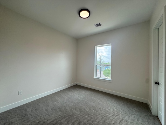 1307 71st St Unit A, Houston, TX 77011 - spare room with baseboards and dark colored carpet