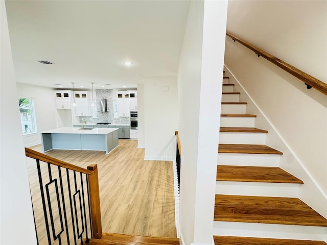 1307 71st St Unit A, Houston, TX 77011 - stairs with wood finished floors and recessed lighting