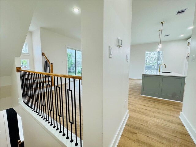 1307 71st St Unit A, Houston, TX 77011 - hall with light wood-type flooring, healthy amount of natural light, an upstairs landing, and recessed lighting