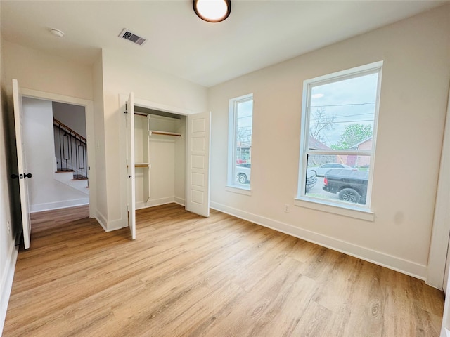 1307 71st St Unit A, Houston, TX 77011 - unfurnished bedroom with light wood finished floors and a closet