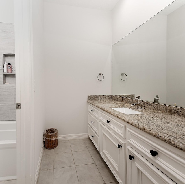 7 Spindrift Pl, The Woodlands, TX 77381 - bathroom featuring vanity, tile patterned floors, baseboards, and a bathtub