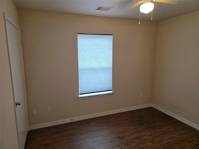 8407 Shady Vista Ct, Houston, TX 77028 - empty room featuring dark wood-style floors, a ceiling fan, and healthy amount of natural light