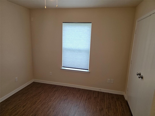 8407 Shady Vista Ct, Houston, TX 77028 - spare room featuring dark wood-style flooring, healthy amount of natural light, and baseboards