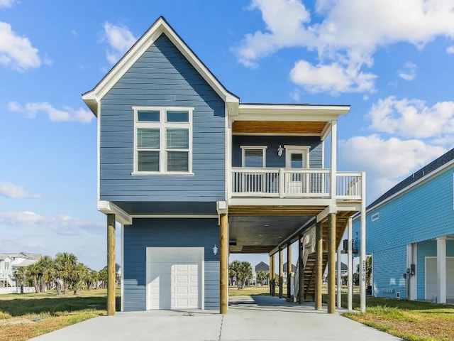 22906 Miramar St, Galveston, TX 77554 - raised beach house with a carport, an attached garage, concrete driveway, and stairway