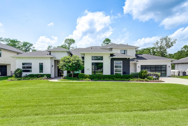 1002 Royal Lakes Manor Blvd, Richmond, TX 77469 - prairie-style house with driveway, a garage, a front lawn, and stucco siding
