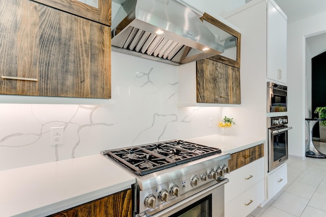 1002 Royal Lakes Manor Blvd, Richmond, TX 77469 - kitchen featuring stainless steel appliances, exhaust hood, white cabinetry, modern cabinets, and light countertops