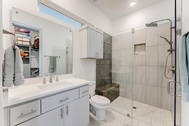 1002 Royal Lakes Manor Blvd, Richmond, TX 77469 - full bath with a shower stall, vanity, toilet, tile patterned floors, and a spacious closet