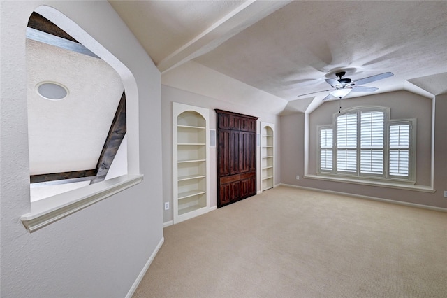 21814 Canton Pass Ln, Katy, TX 77450 - carpeted entryway with lofted ceiling, a ceiling fan, baseboards, and a textured ceiling