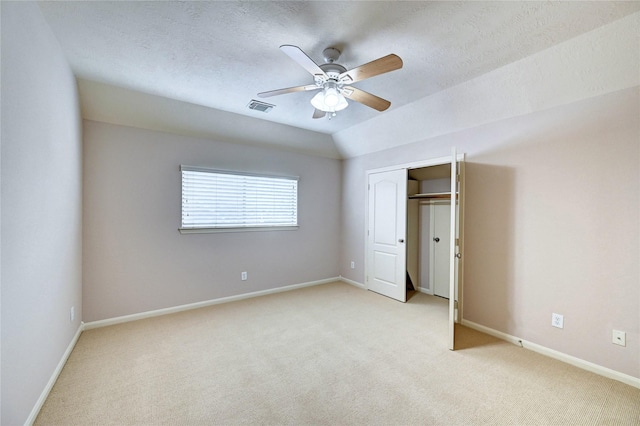 21814 Canton Pass Ln, Katy, TX 77450 - unfurnished bedroom featuring light colored carpet, a closet, baseboards, ceiling fan, and a textured ceiling