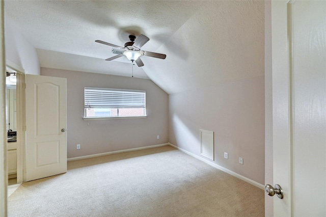 21814 Canton Pass Ln, Katy, TX 77450 - bonus room featuring lofted ceiling, a textured ceiling, carpet flooring, a ceiling fan, and baseboards