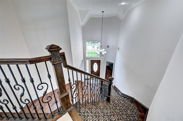21814 Canton Pass Ln, Katy, TX 77450 - staircase with ornamental molding, a chandelier, a towering ceiling, and wood finished floors
