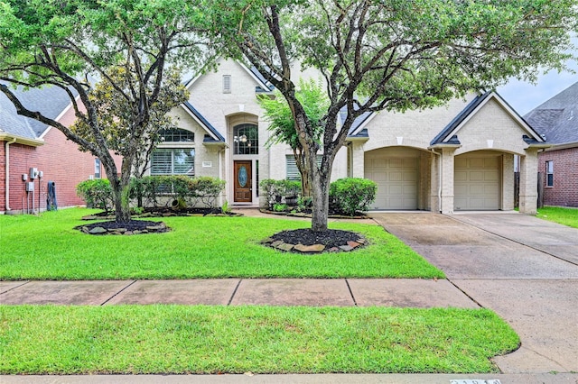 21814 Canton Pass Ln, Katy, TX 77450 - french country home featuring brick siding, concrete driveway, a front yard, and an attached garage
